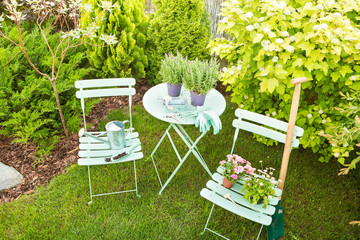 Wall Mural - Spring garden - pastel green table with gardening tools