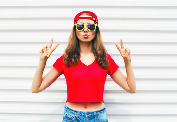 Wall Mural - Fashion pretty cool woman in sunglasses and red t-shirt over whi