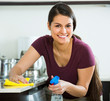 © JackF - brunette dusting in kitchen