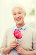 © Syda Productions - happy smiling senior woman with flower at home