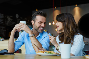 Canvas Print - Happy couple at restaurant eating lunch, having fun