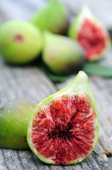 Wall Mural - Whole figs and one fig sliced in half on top of teak garden table