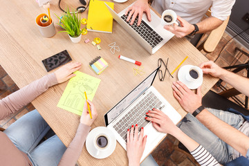 Canvas Print - Cheerful young colleagues working in cooperation