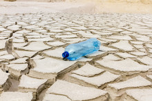 Cracked Earth From Drought Little Water In The Bottle Crack