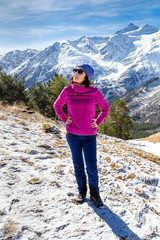 Wall Mural - Young woman admires the snow capped mountains in Georgia