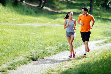 Wall Mural - Beautiful couple jogging in nature