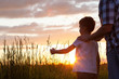 © altanaka - Father and son playing at the park at the sunset time.