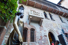 Statue Of Juliet, With Balcony In The Background. Verona, Italy.