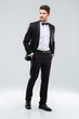 © Drobot Dean - Full length of confident attractive young man in tuxedo