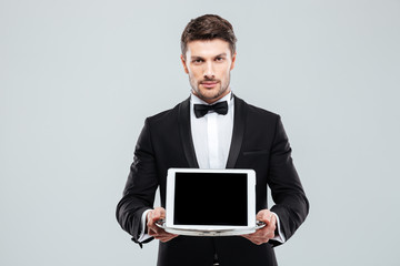 Poster - Butler in tuxedo holding blank screen tablet on tray