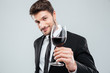 © Drobot Dean - Handsome young man smiling and holding glass of red wine