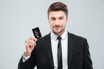 Handsome young businessman holding credit card