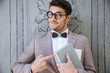 Cute funny man in round glasses pointing on the book