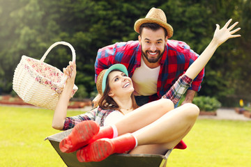 Young couple having fun in the barrow