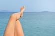 © creativefamily - Woman legs by the seaside enjoying sunny day