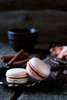 two chocolate macaroon on a dark background