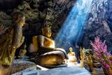 Fototapeta Zachód słońca - Amazing Buddhism with the ray of light in the cave
