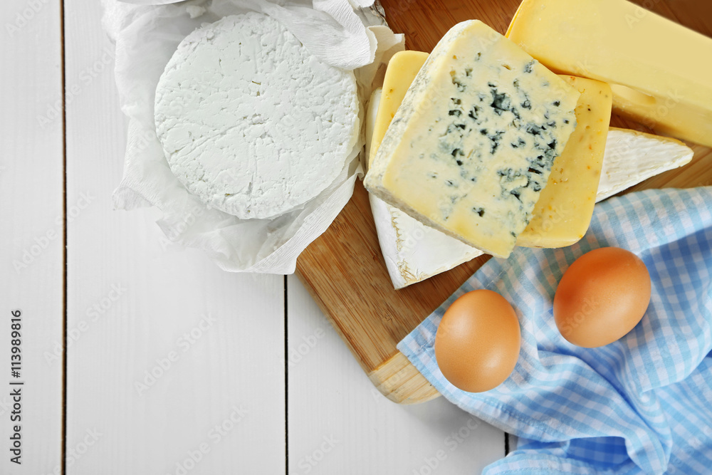 Set of fresh dairy products on white wooden table