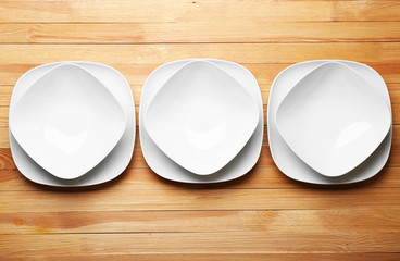 Canvas Print - Set of white dishes on wooden background