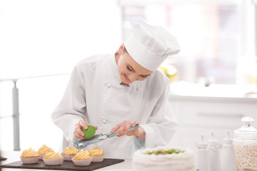 Wall Mural - Female chef working at kitchen