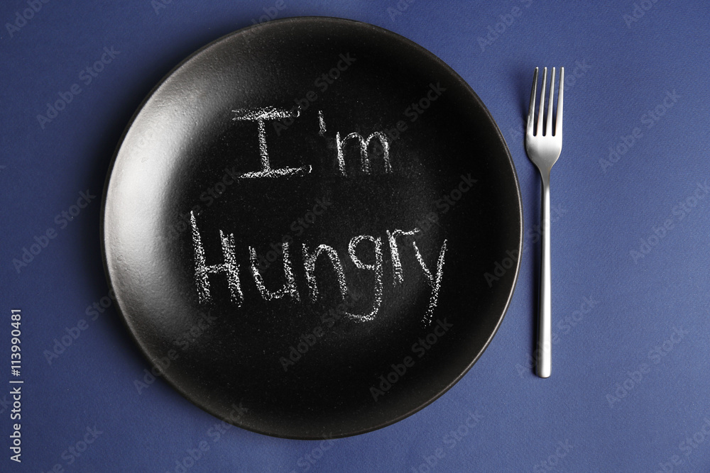 Plate with text I'M HUNGRY on blue background