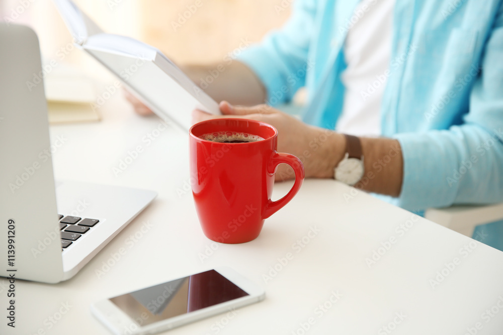 Businessman with coffee working in the office