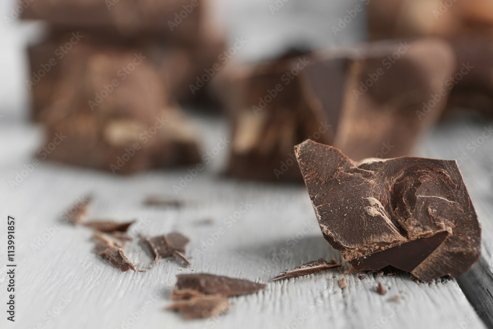 Chocolate pieces on wooden background