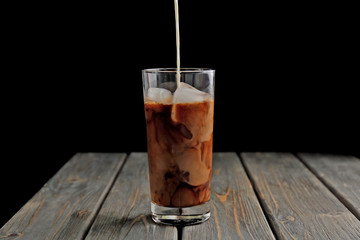 Wall Mural - Glass of iced coffee on wooden table