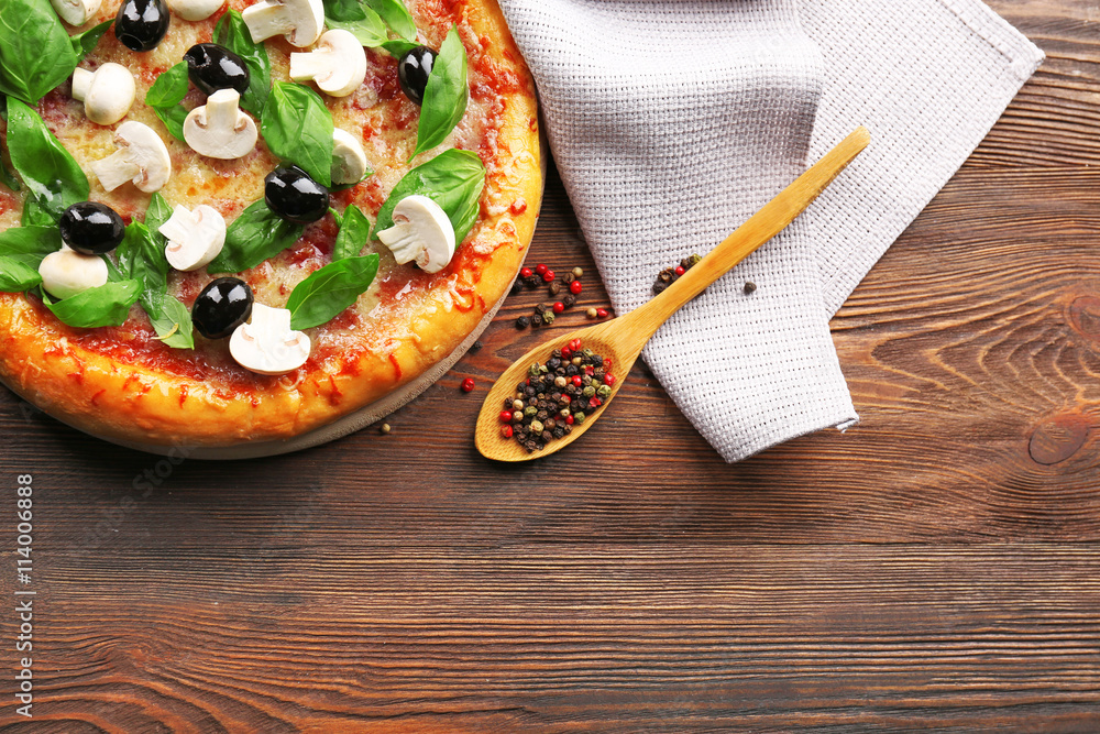 Delicious tasty pizza with ingredients on wooden table