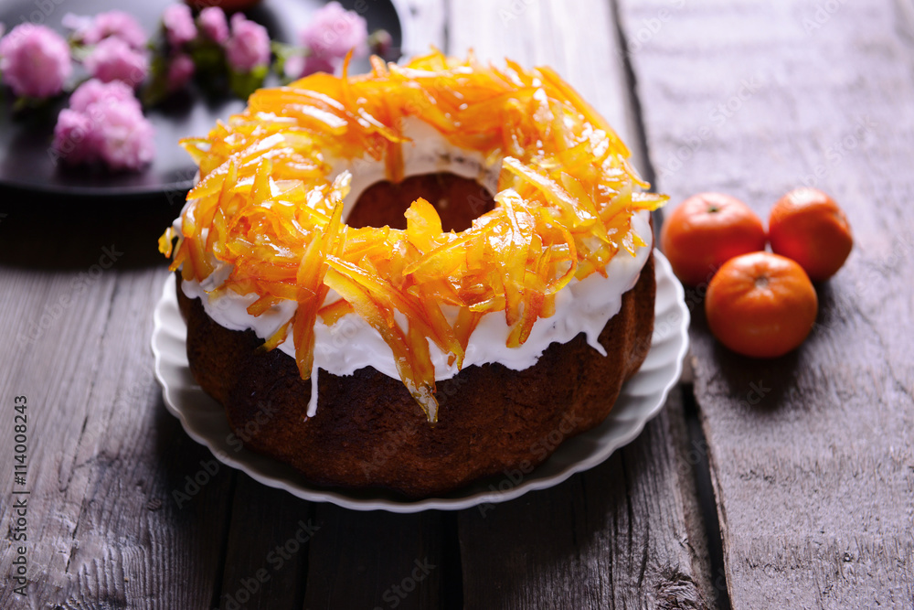 Delicious citrus cake on wooden background