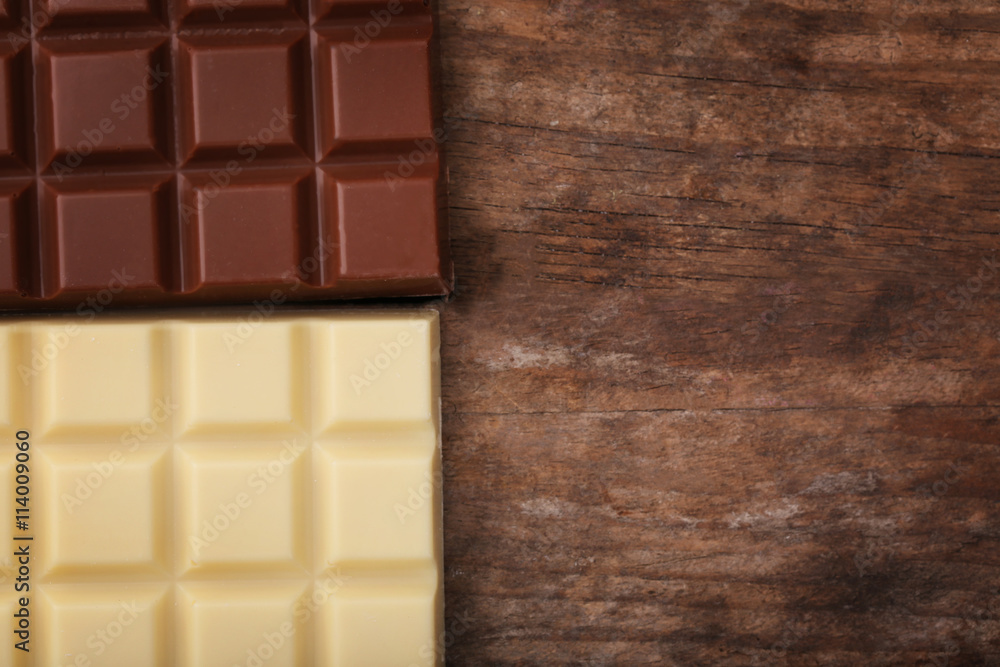 Chocolate bars on wooden background