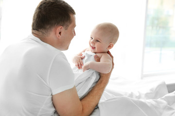 Father playing with smiling baby