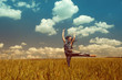 jumping girl on a background of clouds in the summer