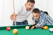 © aletia2011 - father and son playing billiards