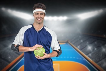 Wall Mural - Composite image of sportsman posing with ball