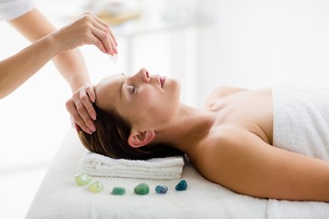 Masseur giving massage treatment to woman