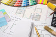 Color samples with house plan, calculator and pen