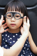 Leinwandbild Motiv Asian Little Chinese Girl Doing Eyes Examination