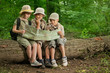 summer camps,scout children camping and read map in forest