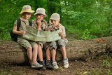 Fototapeta  - summer camps,scout children camping and read map in forest