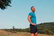 © chrisgraphics - Athletic man in his 30s resting with his hands on his hips while jogging outdoor