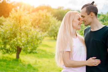 Wall Mural - Couple standing in park and hugging