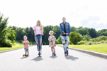 Family with scooters in the park