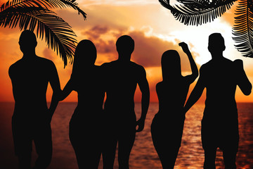 Wall Mural - Young people silhouettes at sunset on the beach