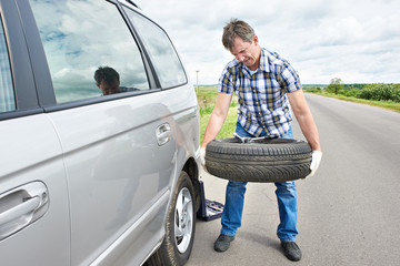 Sticker - Man changing a spare tire of car