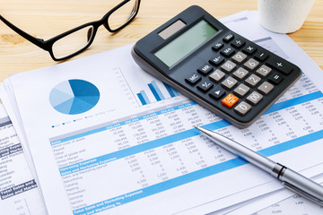 Financial chart with calculator and pen