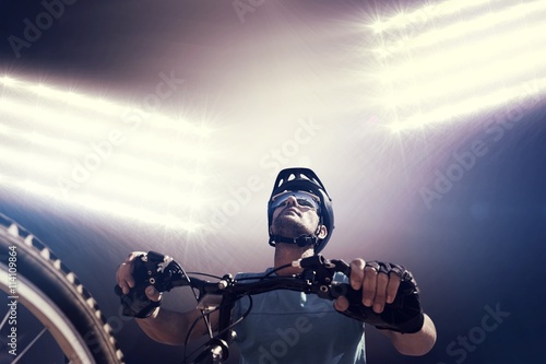 Fotografia Composite image of man cycling with mountain bike