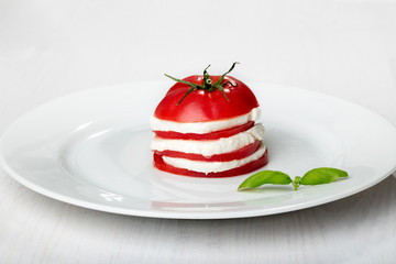 Wall Mural - Tomato and mozzarella slices decorated with basil leaves