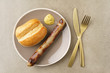 Bratwurst with bread roll and mustard on a plate