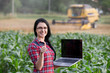 Famer girl with laptop in the field